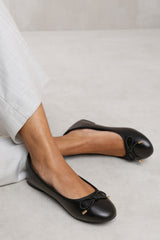 RIDA SLIP ON FLAT PUMPS IN BLACK FAUX LEATHER