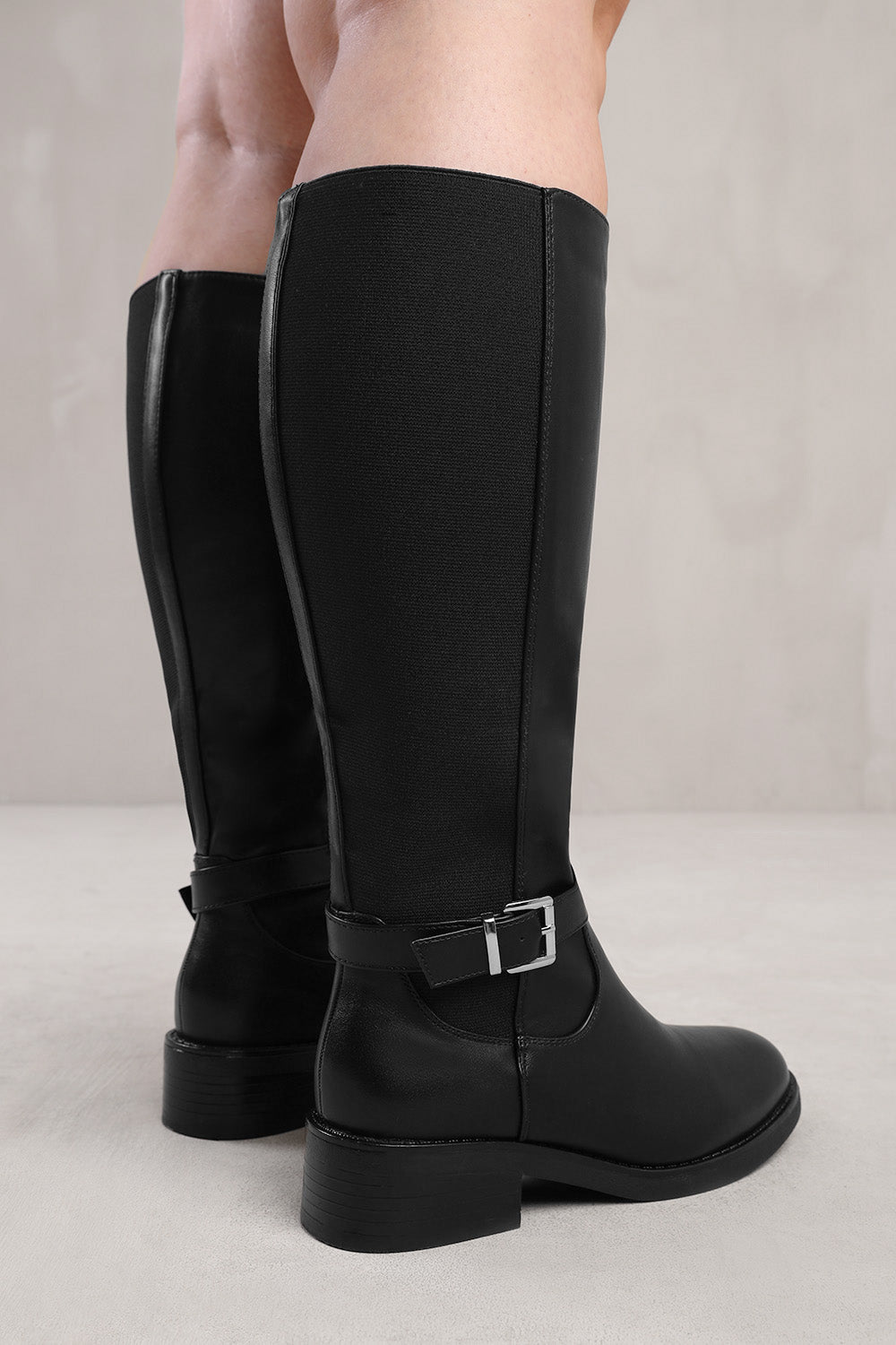 MICAH STRETCH WIDE CALF KNEE HIGH BOOTS WITH BUCKLE DETAIL IN WIDE E FIT IN  BLACK FAUX LEATHER