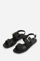 CAMILLA WIDE FIT CLASSIC FLAT SANDALS WITH STRAP AND BUCKLE DETAIL IN BLACK FAUX LEATHER