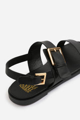 CAMILLA WIDE FIT CLASSIC FLAT SANDALS WITH STRAP AND BUCKLE DETAIL IN BLACK FAUX LEATHER