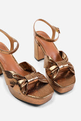 TALIA WIDE FIT MID BLOCK HEEL WITH PLAFTORM AND BOW DETAILING IN GOLD FAUX LEATHER