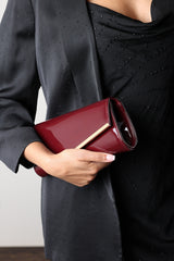Hovena Burgundy Patent Asymmetric Envelope Clutch With Silver Trim