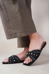 SATURN DOUBLE CROSS OVER STRAP FLAT SANDALS WITH STUD DETAILS IN BLACK FAUX LEATHER