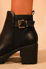 KALI MID BLOCK HEEL WITH BUCKLE DETAIL STRETCH ANKLE BOOTS IN BLACK FAUX LEATHER