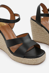 SANSA CUT OUT STRAP DETAIL WEDGE SHOES WITH BUCKLE CLOSURE IN BLACK GRAIN PU