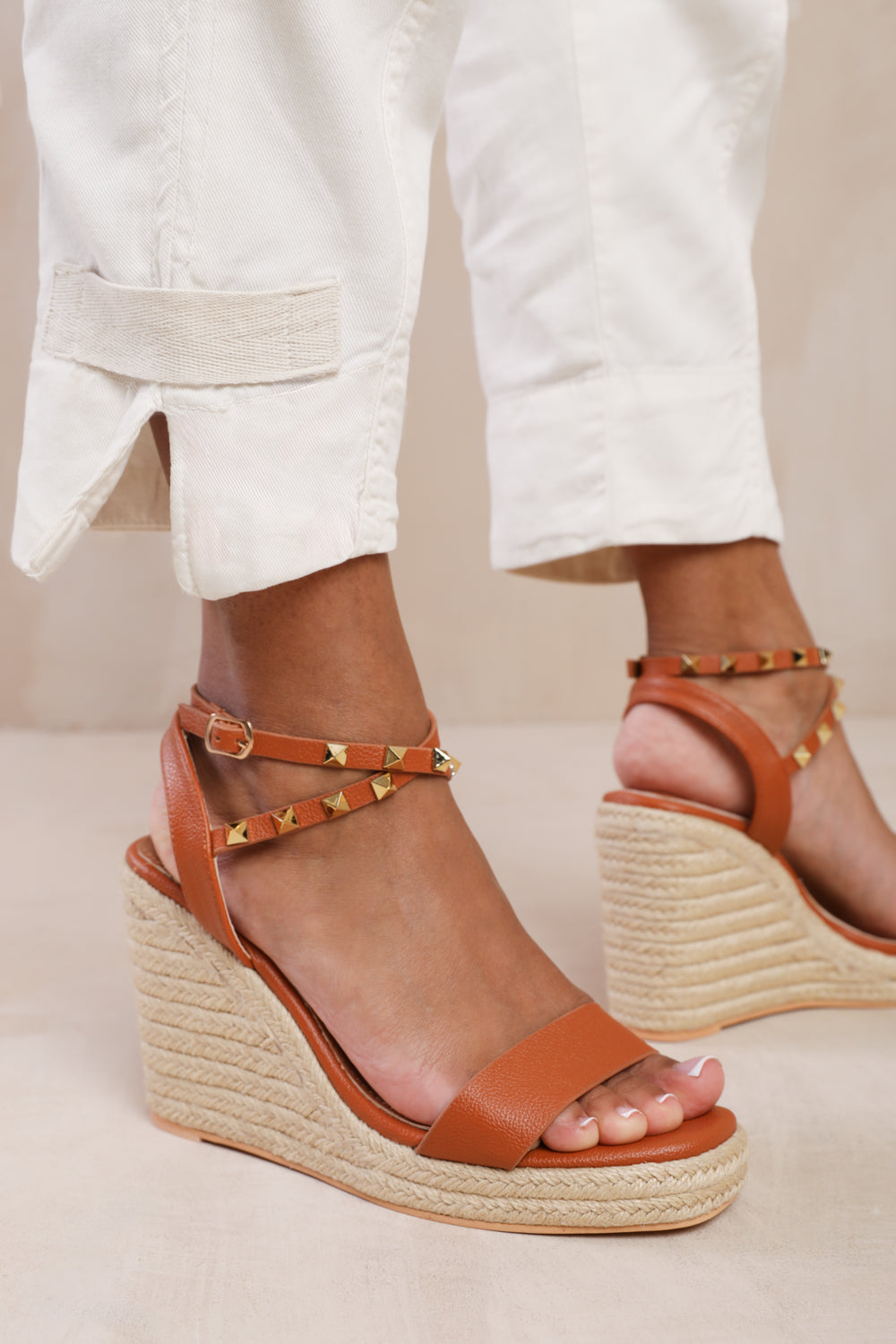 TEXAS CROSS OVER ANKLE STRAP WITH STUDD DETAIL ESPADRILLE WEDGES IN TAN FAUX LEATHER