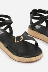 ALORA WIDE FIT CROSS OVER BUCKLE STRAP SANDALS IN BLACK FAUX LEATHER