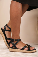 ALORA CROSS OVER BUCKLE STRAP SANDALS IN BLACK FAUX LEATHER