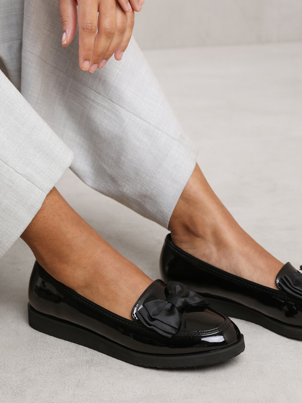 ALPHA SLIP ON LOAFER SLIDER WITH BOW DETAIL IN BLACK PATENT FAUX LEATHER