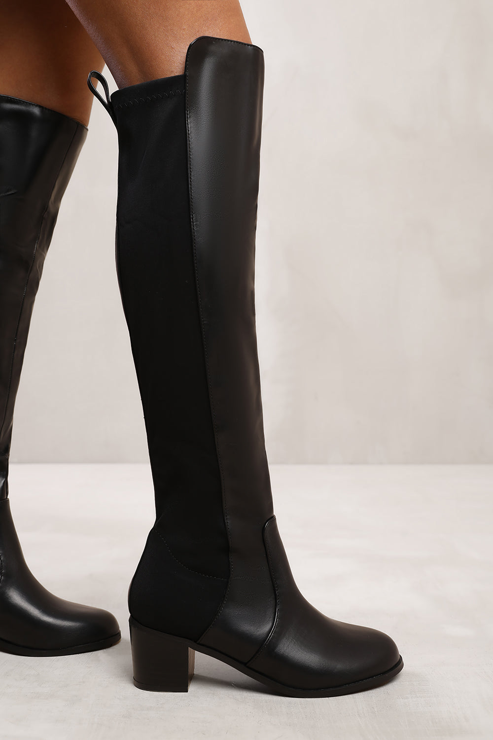 BRITTA THIGH HIGH MID HEELED BOOTS IN BLACK FAUX LEATHER