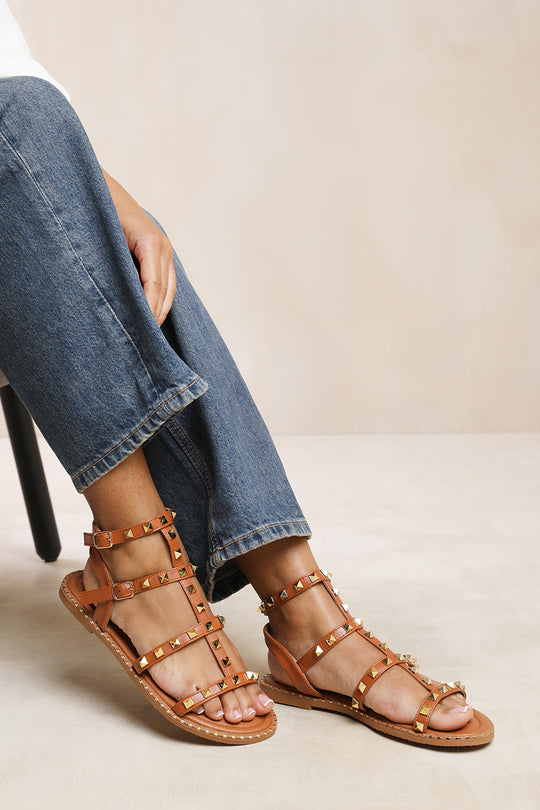NATALIA STUDDED GLADIATOR SANDALS IN TAN FAUX LEATHER