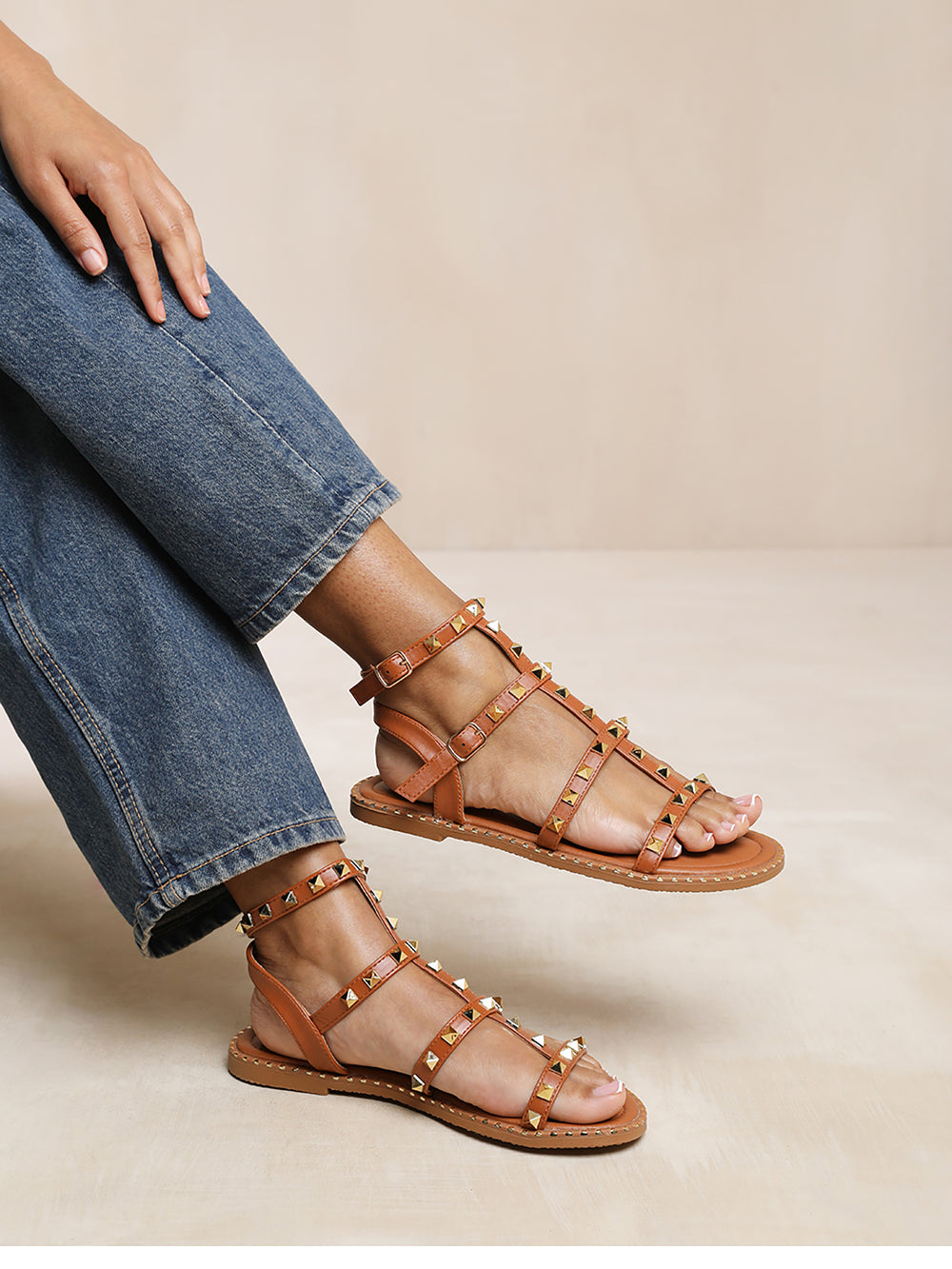 NATALIA STUDDED GLADIATOR SANDALS IN TAN FAUX LEATHER