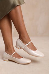 MINSK WIDE FIT LOW HEEL WITH STRAP AND BUCKLE DETAIL IN CREAM PATENT