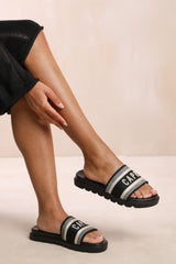 MOON FLAT SANDAL WITH TEXT DETAILING AND PRINTED SOLE IN BLACK