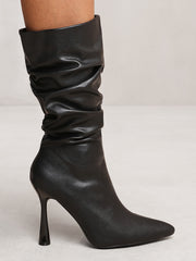 MAEVE MID CALF SLOUCH BOOT WITH HIGH HEEL IN BLACK FAUX LEATHER