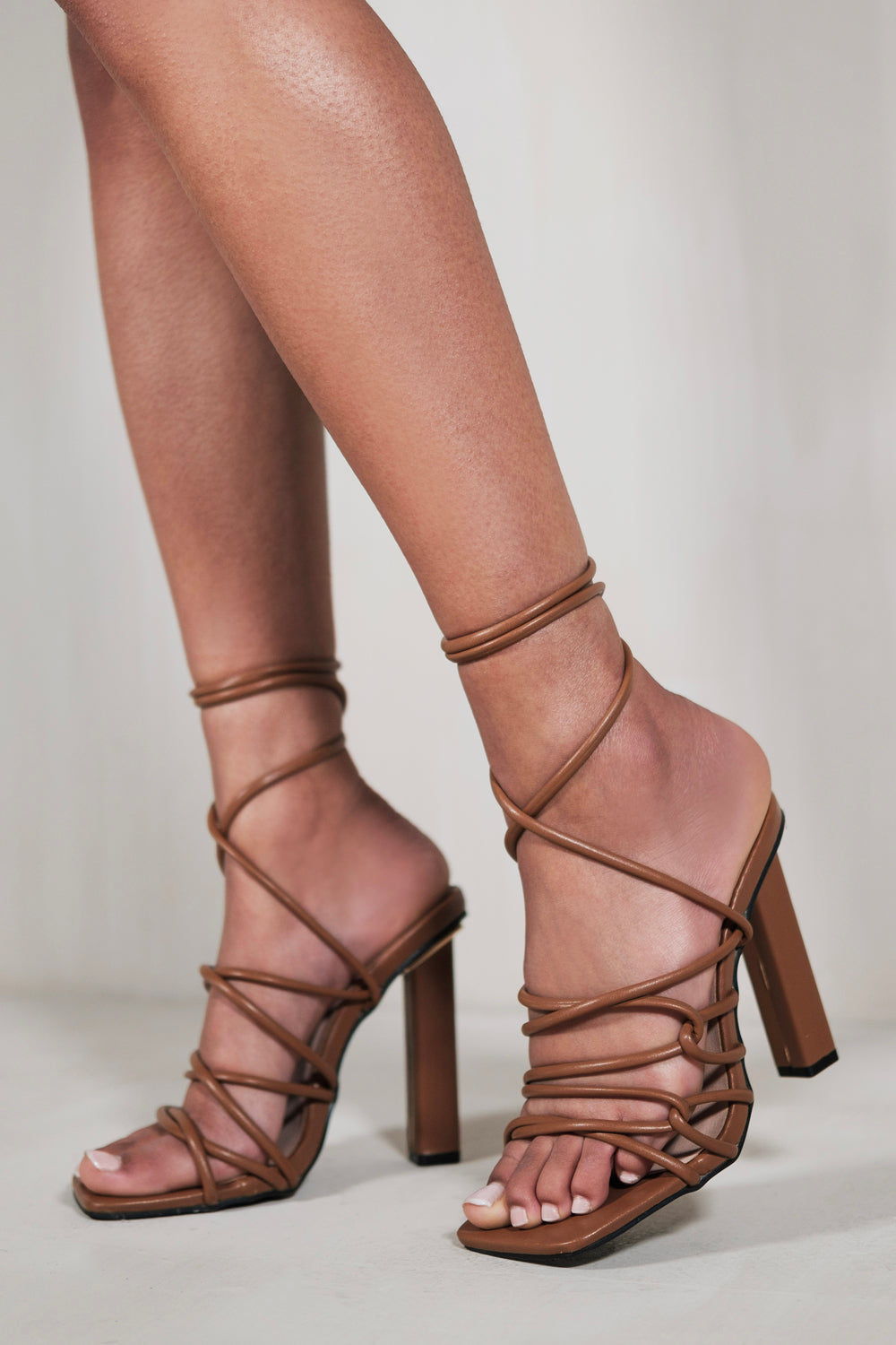 EMILIA HIGH HEELS WITH A TIE LEG AND CROSS OVER STRAP DETAIL IN CHOCOLATE BROWN FAUX LEATHER