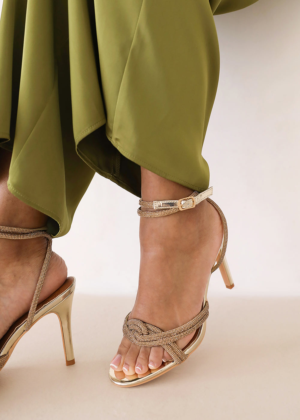 MADON WIDE FIT DIAMANTE KNOT DETAIL WITH CROSS OVER ANKLE STRAP HIGH HEELS IN GOLD CHROME