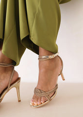 MADON DIAMANTE KNOT DETAIL WITH CROSS OVER ANKLE STRAP HIGH HEELS IN GOLD CHROME