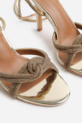 ISEPPA DIAMANTE KNOT DETAIL WITH CROSS OVER ANKLE STRAP HIGH HEELS IN GOLD CHROME