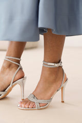 ISEPPA DIAMANTE KNOT DETAIL WITH CROSS OVER ANKLE STRAP HIGH HEELS IN SILVER CHROME