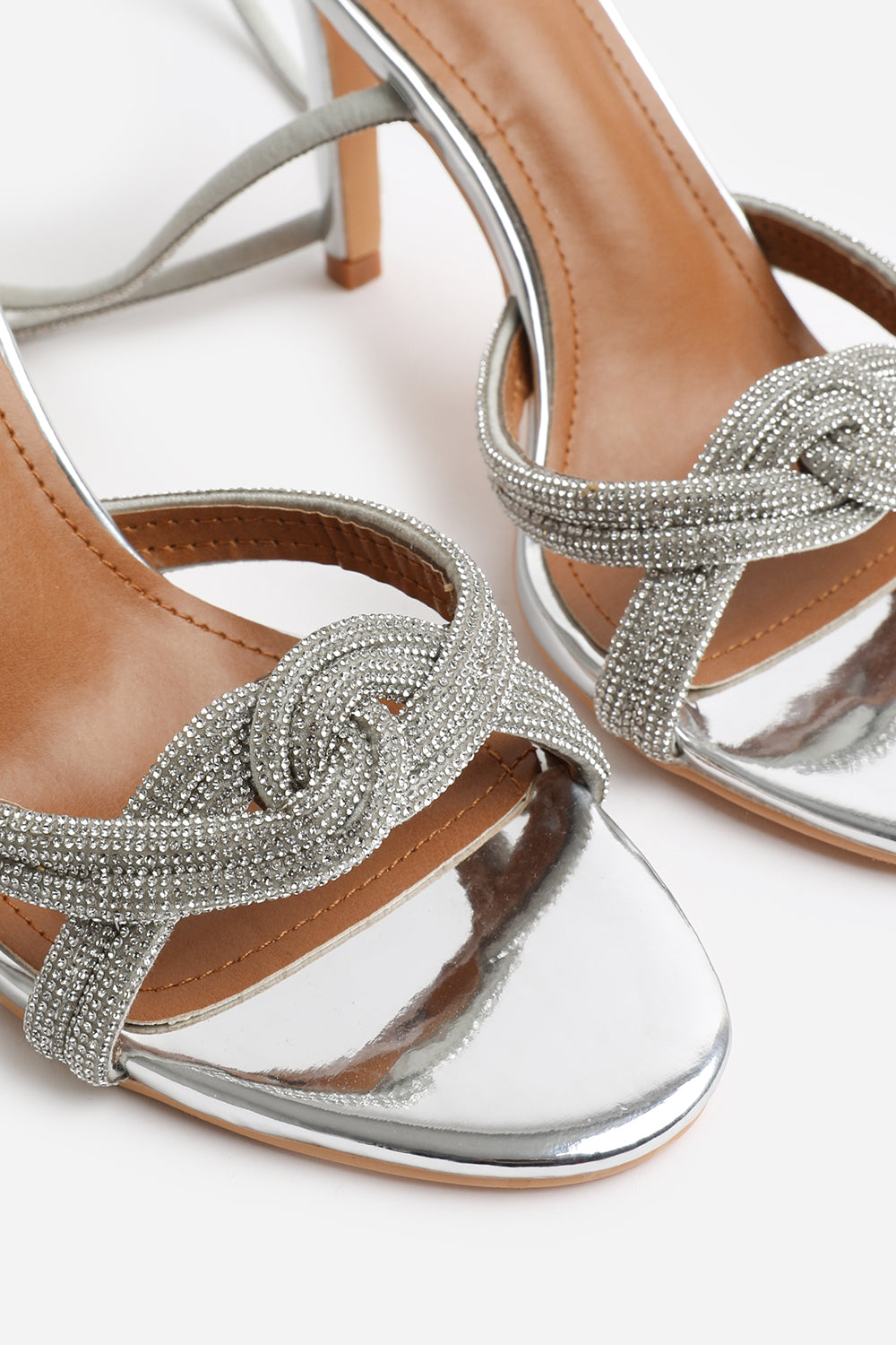 ISEPPA DIAMANTE KNOT DETAIL WITH CROSS OVER ANKLE STRAP HIGH HEELS IN SILVER CHROME