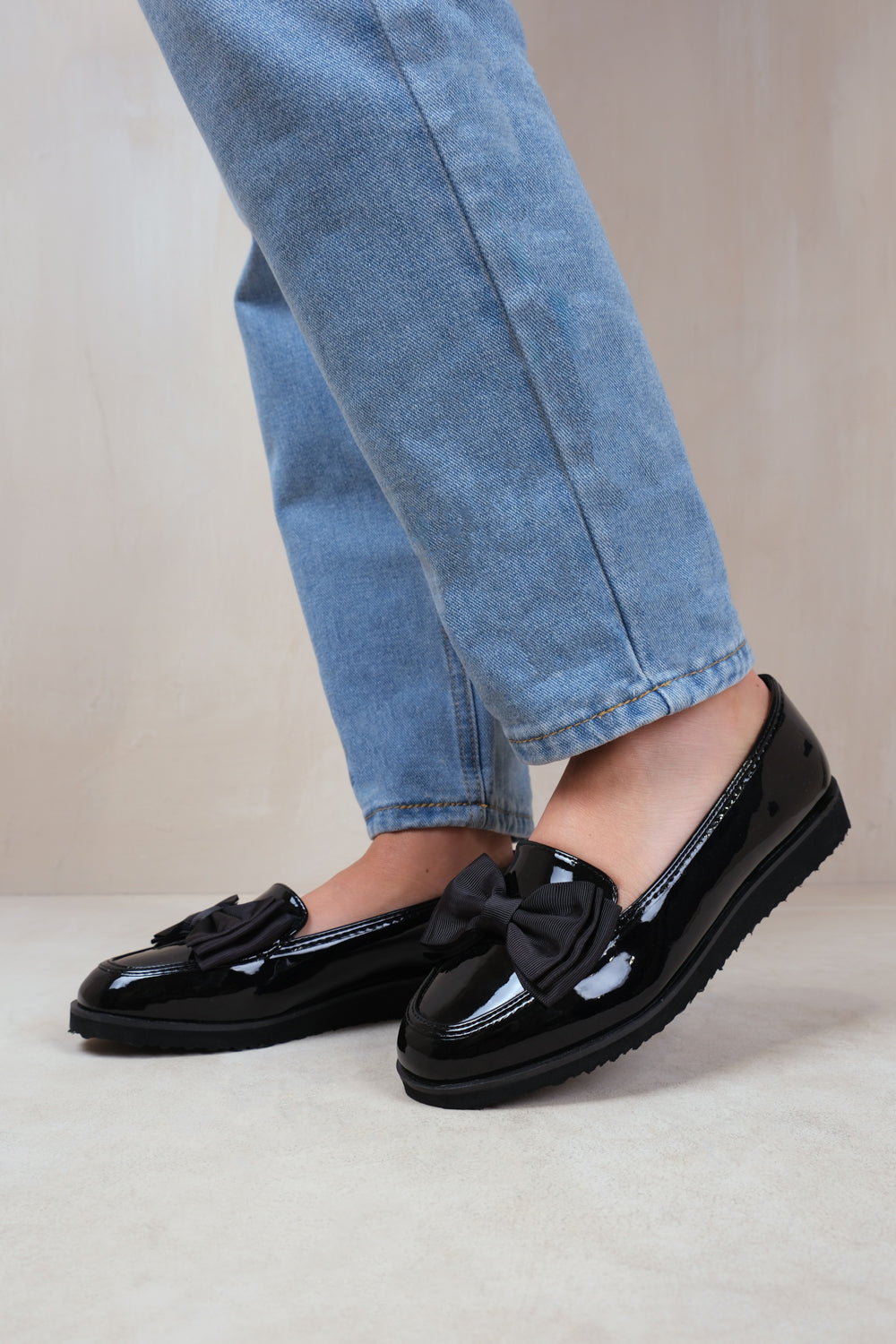 ALPHA SLIP ON LOAFER SLIDER WITH BOW DETAIL IN BLACK PATENT FAUX LEATHER