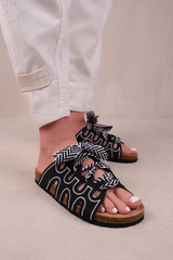 PARADOX STRAPPY FLAT SANDALS WITH PRINTED RIBBON DETAILING IN BLACK FAUX LEATHER