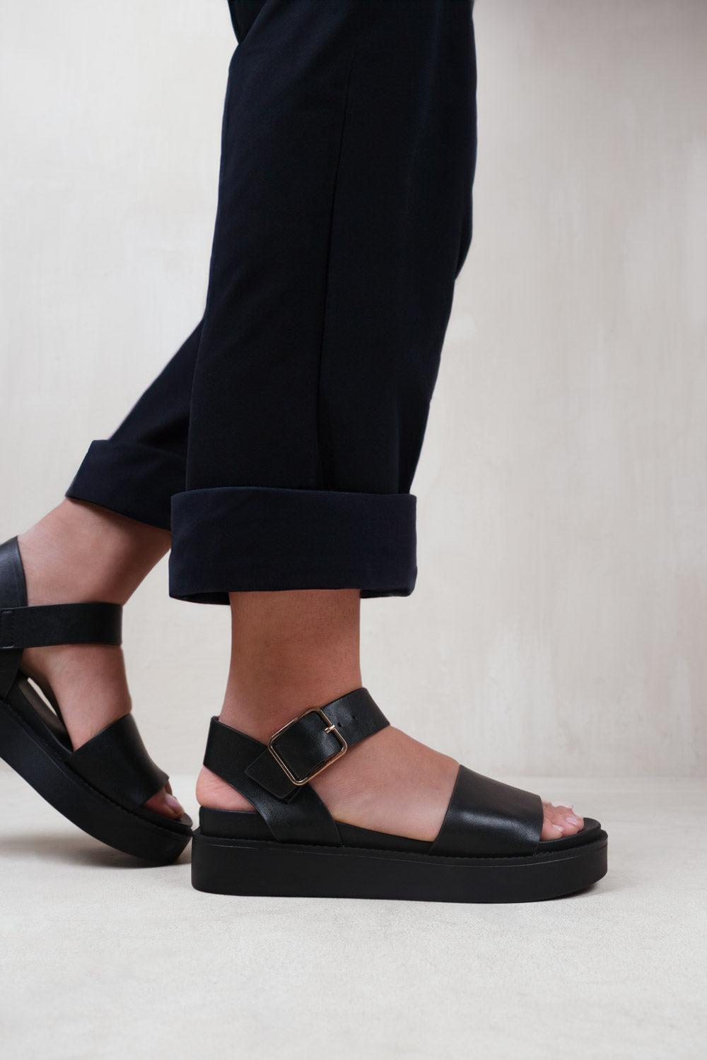 PHOENIX EXTRA WIDE FIT CLASSIC FLAT SANDALS WITH STRAP AND BUCKLE DETAIL IN BLACK FAUX LEATHER