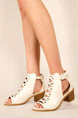 REYDAH MID HIGH BLOCK HEEL SANDALS WITH PEEP TOE & CRISS CROSS DETAIL IN WHITE FAUX LEATHER
