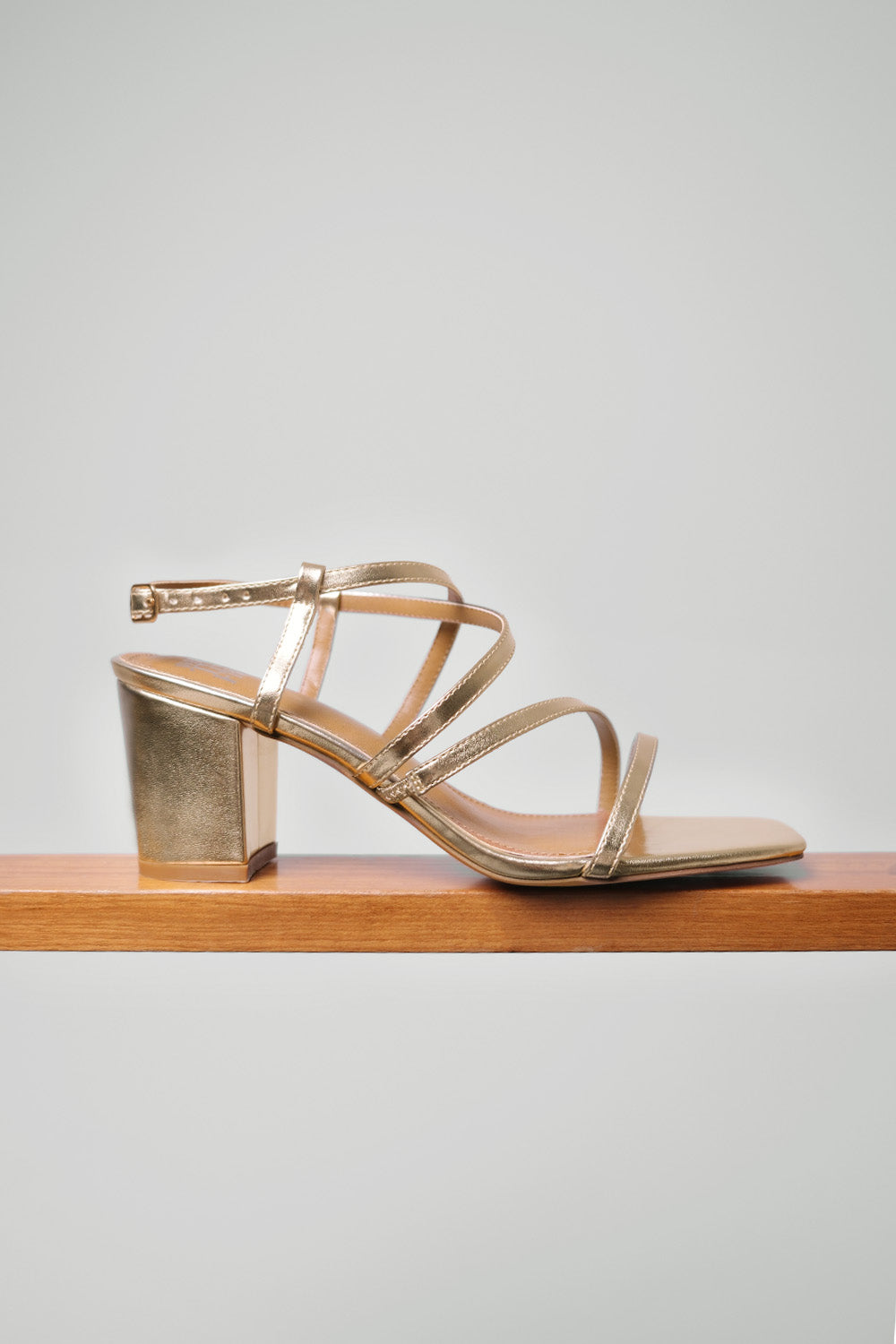 SIDRA MID HIGH BLOCK HEEL SANDALS WITH CROSS OVER STRAP IN GOLD METALLIC FAUX LEATHER