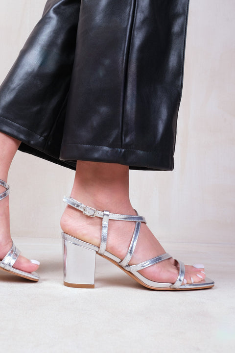 SIDRA WIDE FIT MID HIGH BLOCK HEEL SANDALS WITH CROSS OVER STRAP IN SILVER METALLIC FAUX LEATHER