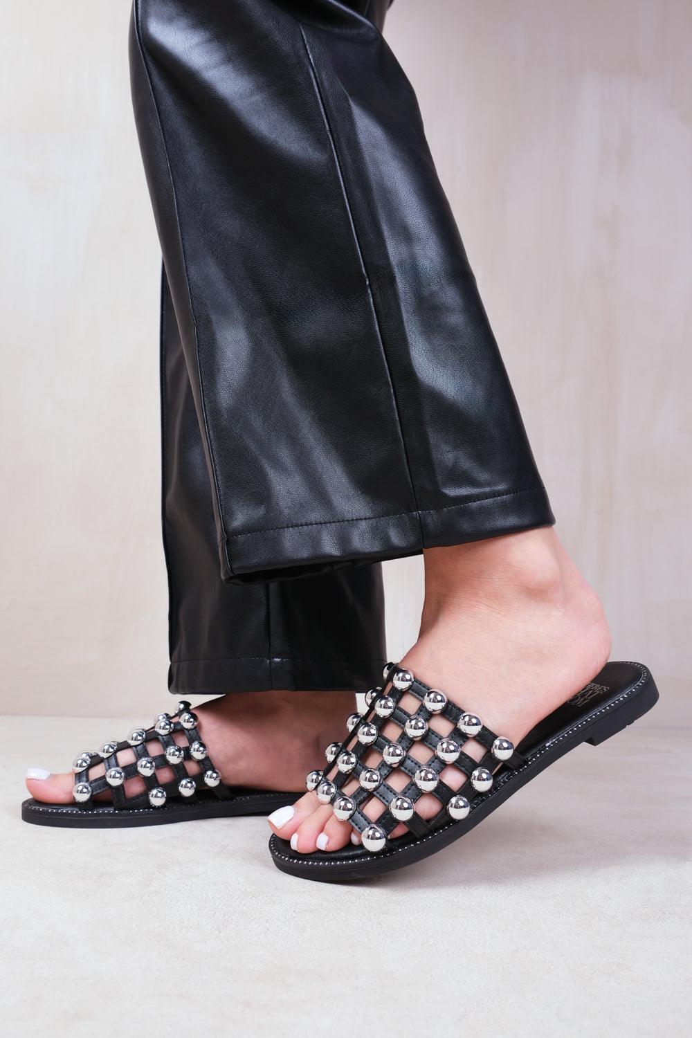 KELLY STUDDED SLIDER WITH CAGED STUDDED DETAILING IN BLACK FAUX LEATHER