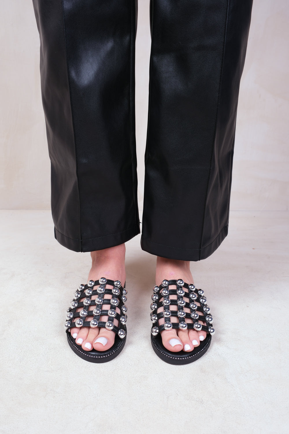 KELLIE WIDE FIT SLIDER SANDALS WITH CAGED STUDDED DETAILING IN BLACK FAUX LEATHER